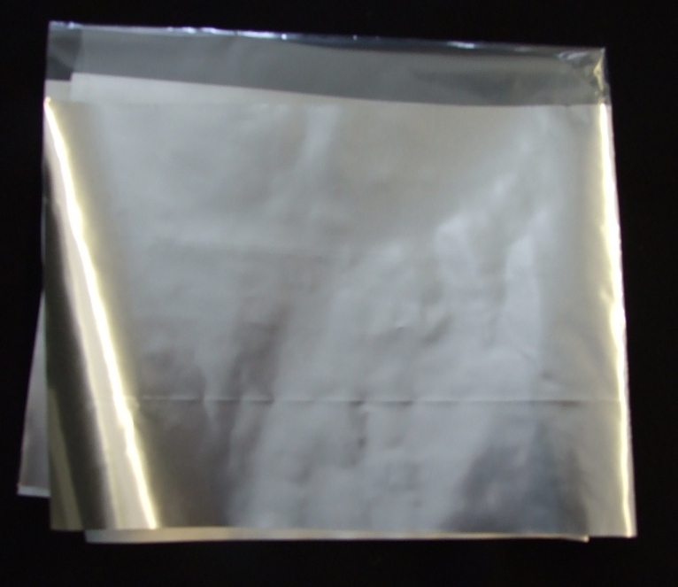 LAMINATED FILM /FOIL STRUCTURE SUPPLIED IN REEL FORMAT ONTO A CARDBOARD CORE FOR USE AS PACKAGING OF FOOD PRODUCTS. STRUCTURE - 12MM POLYETHYLENE TEREPHTHALATE/7MM FOIL /30MM POLYETHYLENE TEREPHTHALATE FLEXOGRAPHICALLY PRINTED AND LAMINATED USING POLYURETHANE SOLVENT FREE ADHESIVES.