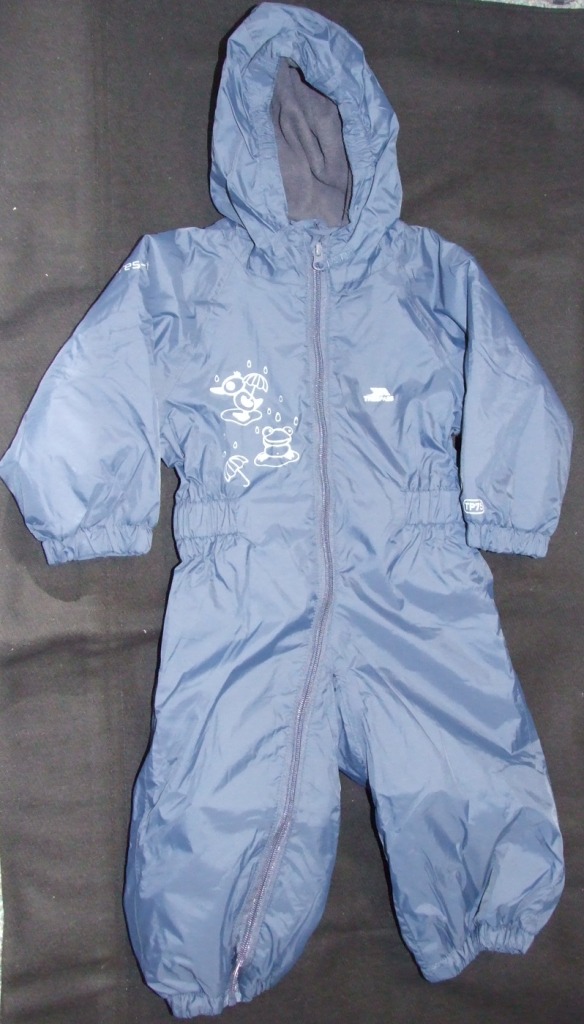 A BABIES WOVEN  ALL IN ONE GARMENT. DESIGNED TO COVER THE WHOLE OF THE BODY FROM THE SHOULDERS TO THE FEET, ENVELOPING EACH LEG SEPARATELY. WITH A HOOD. WITH LONG SLEEVES WITH ELASTICATED CUFFS. WITH A FULL FRONT ZIP FASTENING FROM THE NECK TO ANKLE. OF 100% SHELL POLYMIDE/PU COATING. NOT CONSIDERED TO BE VISIBLY COATED TO THE NAKED EYE. WITH APPLIED LOGOS TO FRONT AND SLEEVE. LABEL STATES DESIGNED FOR BABIES AGED 12 -18 MONTHS.