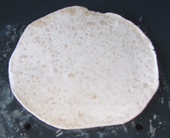 WHOLEMEAL CHAPATTI, (FLAT UNLEAVENED ROUND BREAD ALSO KNOWN AS ROTI), MADE FROM WHOLEMEAL WHEAT FLOUR, WATER, PALM OIL AND SALT. THE CHAPATTI IS IN THE FORM OF FROZEN UNCOOKED DOUGH IN THE SHAPE OF A DISC,  PRESENTED IN QUANTITIES OF 8 IN A PLASTIC POUCH. INTENDED TO BE PAN COOKED FROM FROZEN.