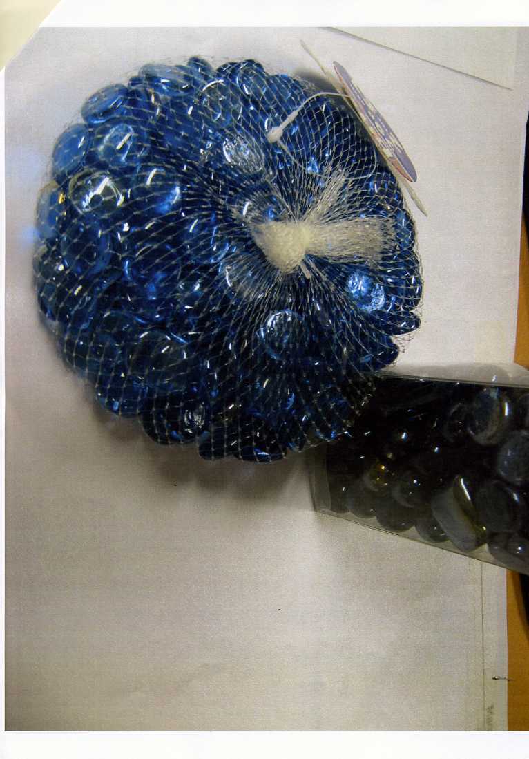 COLOURED GLASS PEBBLES FOR DECORATION PURPOSES. PACKAGED IN A NETTING BAG.