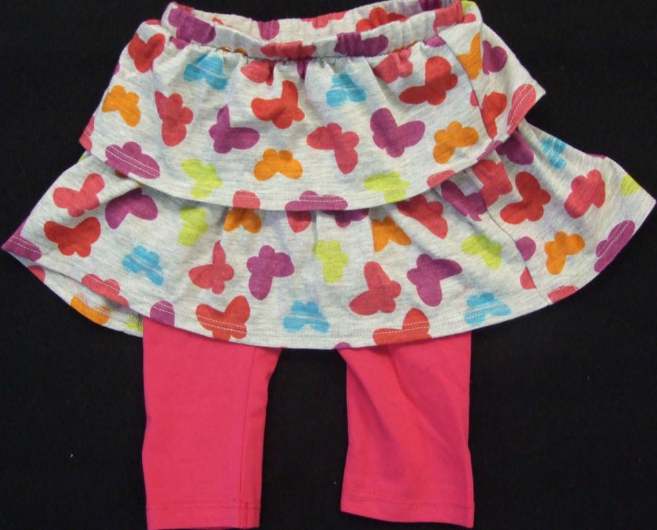 KNITTED LEGGINGS DESIGNED TO COVER THE BODY FROM THE WAIST TO JUST ABOVE THE ANKLE. WITH ELASTICATED WAISTBAND. HEMMED AT LEG ENDS. WITH OVERSKIRT IN TWO TIERS  ATTACHED AT THE WAISTBAND. LEGGINGS 95 PER CENT COTTON, 5 PER CENT ELASTINE. SKIRT 100 PER CENT COTTON.