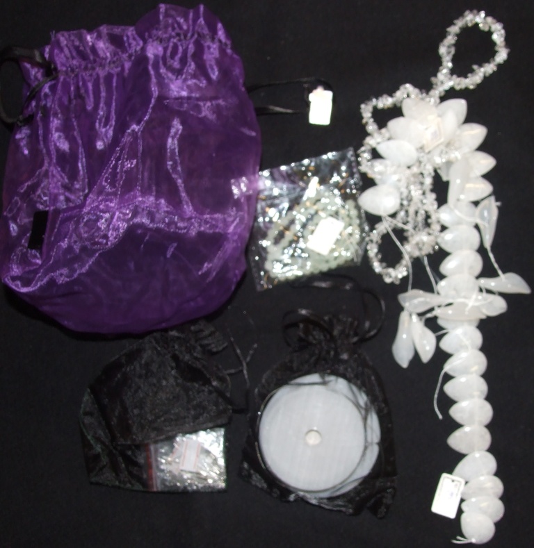 A JEWELLERY KIT COMPRISING OF JADE FLAT DROP BEADS, JADE CATTLE EAR BEADS, WHITE QUARTZ CHIPS,  FACETED BEADS, CRIMPS, CLASPS, HEADPINS AND TWO DIFFERENT TYPES OF WIRE, CONTAINED IN TWO GIFT BAGS.
