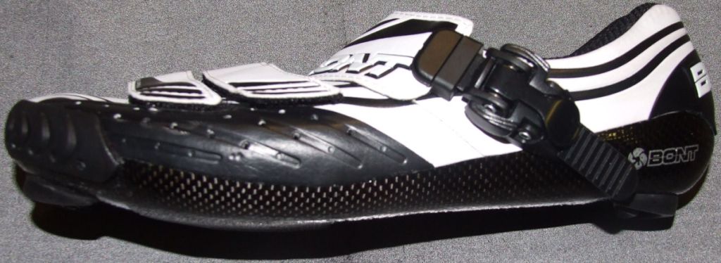 A CYCLING SHOE. THE SHOE IS MADE FROM THE INSIDE OUT. EVERYTHING IS LAMINATED TOGETHER BY THE EPOXY RESIN SO IT FORMS A MONOCOQUE. CARBON FIBRE IS THEN HAND LAYED. AIRCRAFT GRADED CARBON IS WEAVED ON THE OUTSIDE AND UNDIRECTIONAL CARBON ON THE INSIDE. THE UNI DIRECTIONAL CARBON HAS ONLY HALF THE STRANDS OF CROSS WEAVE CARBON. IT GIVES STRENGTH IN ONE DIRECTION SO IT SAVES WEIGHT BY USING LESS CARBON OF ABSORBING LESS RESIN. THE SHOE HAS AN AUTRALIAN LEATHER UPPER.