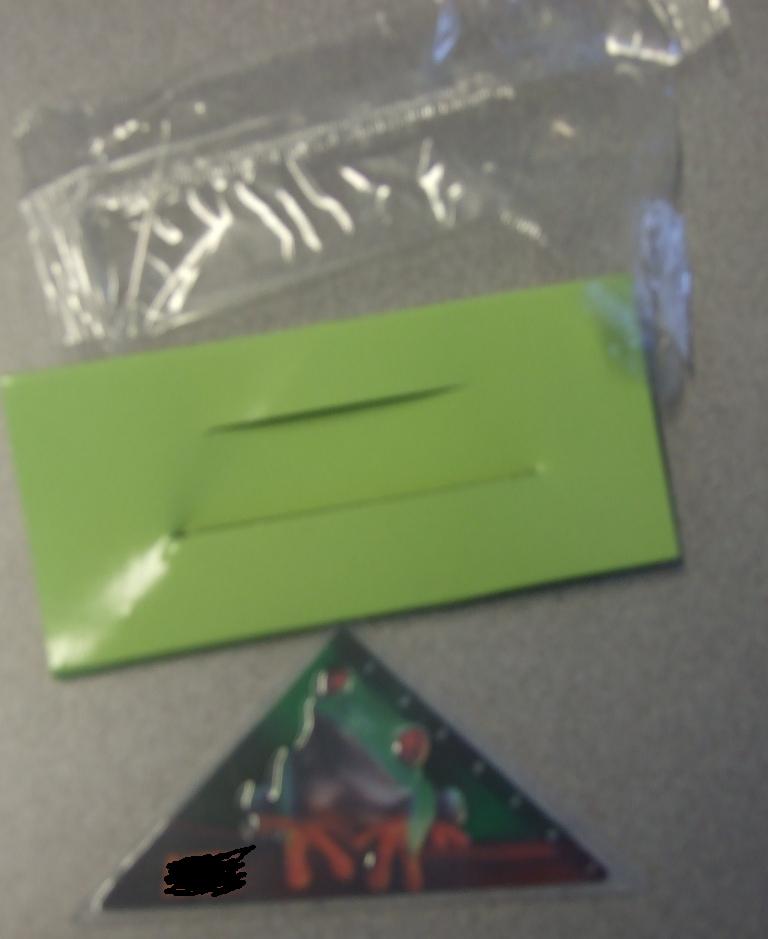 THIS IS A 45 DEGREE SET SQUARE PRODUCED IN PLASTIC. WITH PRINTED FROG DESIGN. THE EDGE OF THE SET SQUARE HAS GRADUATIONS SO IT MAY BE USED AS A RULER. THIS PRODUCT IS USED AS A MEASURING DEVICE IN MATHEMATICAL SUBJECTS.PACKAGED IN A PAPERBOARD SLEEVE INSIDE A PLASTIC BAG.