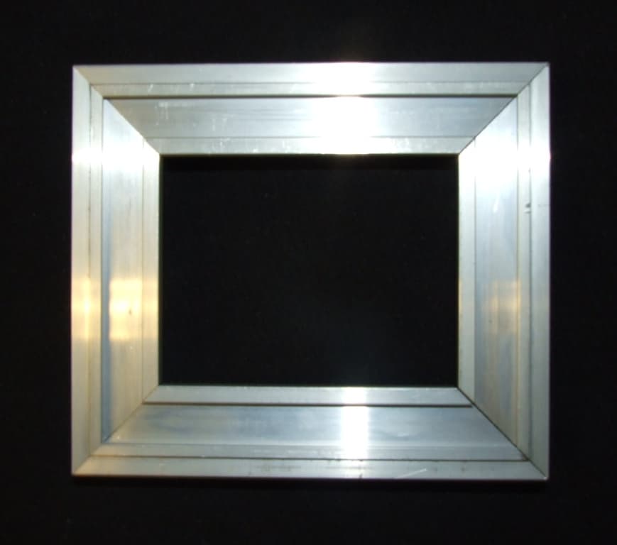 EXTRUDED PROFILE OF ALUMINIUM ALLOY IN A L SHAPE. TO BE CUT TO CORRECT LENGTH AND FIXED INTO CONCRETE FLOOR AS A FRAME FOR FLOORING SYSTEMS.