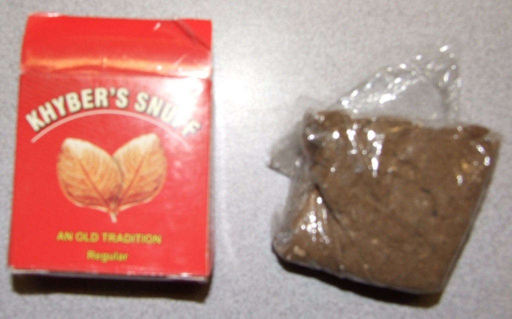 THE PRODUCT IS  NASWAR , DESCRIBED AS KHYBER SNUFF . PACKAGED FOR RETAIL SALE IN A RED PACKET . IT IS IN THE FORM OF A MOIST COARSE POWDER.  PLACED IN THE MOUTH BETWEEN THE GUMS AND LIPS. INGREDIENTS INCLUDE AIR CURED TOBACCO,, STEM, WOOD ASH, MENTHOL, LIMESTONE AND AQUA.
