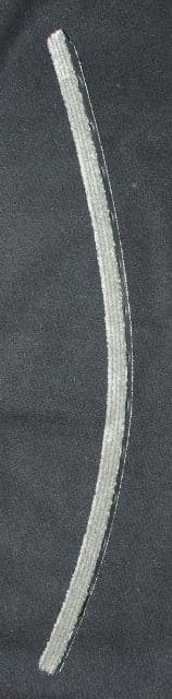 RUBBER FLOOR COVERING OF NON-CELLULAR RUBBER WITH POLYAMIDE TUFTED SURFACE TOP AND BOTTOM TO ALLOW THE MAT TO BE REVERSED AND USED BOTH SIDES. A RUBBER STRIP APPROX 14MM WIDE X 17 MM HIGH HAVING TEXTILE FIBRES EMBEDDED WITHIN IT AND THAT HAS BEEN CUT FROM A LARGER SHEET. THE STRIPS ARE THEN DRILLED ALONG THE SIDE WITH A SERIES OF HOLES TO ALLOW METAL RODS TO BE PASSED THROUGH FOR SECURING INTO A GRID.