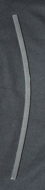 RUBBER FLOOR COVERING OF NON-CELLULAR RUBBER. A RUBBER STRIP APPROX 14MM WIDE X 17 MM HIGH HAVING TEXTILE FIBRES EMBEDDED WITHIN IT AND THAT HAS BEEN CUT FROM A LARGER SHEET. THE STRIPS ARE THEN DRILLED ALONG THE SIDE WITH A SERIES OF HOLES TO ALLOW METAL RODS TO BE PASSED THROUGH FOR SECURING INTO A GRID.
