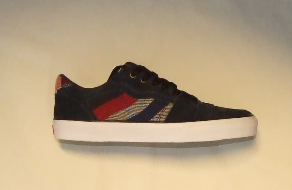 UNISEX SKATEBOARDING SHOE. NAVY BLUE AND RED IN COLOUR.  NOT COVERING THE ANKLE. UPPER IS LEATHER (SUEDE) AND TEXTILE WHERE THE LEATHER PREDOMINATES. BROWN LACES. OUTER SOLES MADE OF  SOFT VULCANIZED MULTI DIRECTIONAL RUBBER  WITH A SNOWCAP PATTERN. SPECIAL TECHNOLOGY IN THE FORM OF A HYPERSTRETCH GEL IN THE MIDSOLE HEEL SECTION. LOGO IS SHOWN ON THE HEEL. -  INSOLE LENGTH OF MORE THAN 24 CM.  PRICE EXCEEDS 7.5 EUROS.