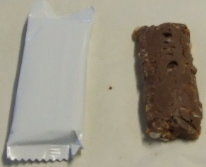 A CEREAL BAR COATED ON THE UNDERSIDE WITH CHOCOLATE.  INGREDIENTS INCLUDE: DIGESTIVE CHUNKS, GLUCOSE SYRUP, MILK CHOCOLATE,  OATS, ROASTED HAZELNUTS, BRAN FLAKES, CANE SYRUP,  RICE CRISP, WHEY POWDER, HIGH OLEIC SUNFLOWER, GLYCERINE, TREACLE, LECITHIN AND SALT. MANUFACTURING PROCESS IS MIX, SET AND THEN CUT INTO PIECES. INDIVIDUALLY WRAPPED IN A PRINTED PLASTIC WRAPPER, SEALED EITHER END AND ALONG THE BACK.