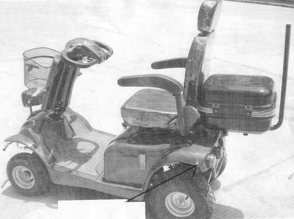 A MOBILITY SCOOTER WHICH IS AN ELECTRICAL PROPELLED CARRIAGE FOR DISABLED AND ELDERLY PEOPLE.  IT HAS A MAXIMUM SPEED NOT EXCEEDING 15KM/H.  THE VEHICLE CONSISTS OF A WELDED STEEL FRAME WITH FOUR WHEELS.  MOST OF THE FRAME IS COVERED BY A THERMO MOULDED PLASTIC COVER (CHASSIS).  IT HAS A SINGLE SEAT WITH ARM RESTS,   OPTIONAL/DEMOUNTABLE STORAGE BOX AT THE REAR AND A DETACHABLE FRONT BASKET.  THE VEHICLE IS POWERED BY AN ELECTRIC MOTOR, WHICH IS ATTACHED TO A TRANSMISSION SYSTEM WHICH FORMS THE REAR AXLE.