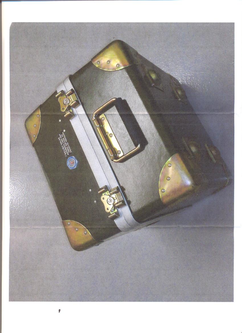 PLASTIC FIBRE GLASS RIGID CASE. MADE FROM PLASTIC EMBEDDED WITH GLASS FIBRES. AN EMPTY CASE WITH NO INTERNAL FITTINGS, INTENDED TO HOUSE A 126 TEST KIT. WITH A PRESSURE RELIEF VALVE BUTTON, METAL CLIP FASTENINGS AND A METAL CARRY HANDLE. DIMENSIONS 37 X 37 X 34 CM. BLACK IN COLOUR.