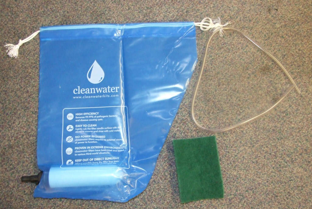 A WATER FILTRATION SYSTEM CONSISTING OF A 7 INCH CERAMIC CANDLE, 2 WASHERS, 1 PLASTIC CONNECTOR, PLASTIC SYPHON TUBE, ABRASIVE SCOURER, 1 HOOK, 1 METAL HOLE MAKER, 1 HEAVY DUTY POLYTHENE FILTER BAG, INSTRUCTION SHEET AND DIE CUT PACKAGING BOX AND LABEL.