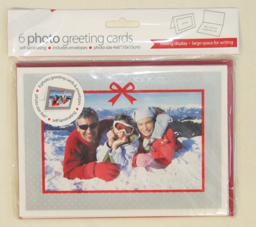 A PACK OF 6 GREETINGS CARDS WITH ENVELOPES.  THE CARDS HAVE A SELF-ADHESIVE FRAME TO HOLD A 6 X 4 INCH PHOTOGRAPH AND HAVE THE TEXT "MERRY CHRISTMAS & HAPPY NEW YEAR" INSIDE.  AVAILABLE IN TWO FRAME DESIGNS: RED WITH SILVER DOT AND A SILVER BOW AND SILVER WITH WHITE DOTS AND A RED BOW.  PACKAGED FOR RETAIL SALE IN A HANGING PLASTIC BAG.  FOLDED CARDS MEASURE 17.8 X 12.8 CM.