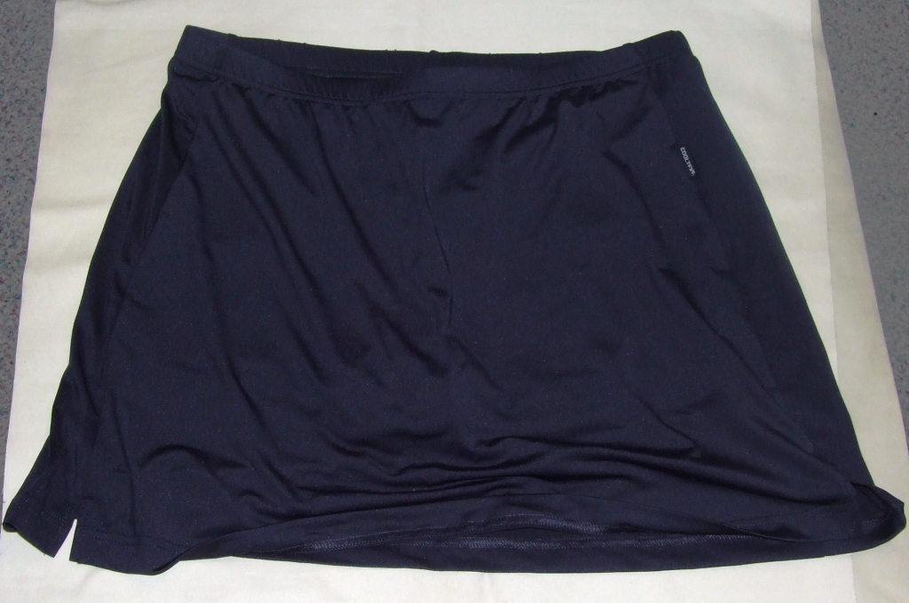 A KNITTED SKORT FOR WOMEN.  DESIGNED TO COVER THE LOWER PART OF THE BODY FROM THE WASTE TO MID THIGH.  WITH TIGHT FITTING SHORTS ATTACHED TOTALLY COVERED BY THE OVERSKIRT.  WITH AN ELASTICATED WAIST (NO OPENING).  THE SKIRT AND SHORTS ARE FULLY HEMMED AND THE SKIRT HAS TWO SMALL SLITS EITHER SIDE.  90% POLYESTER AND 10% ELASTANE.