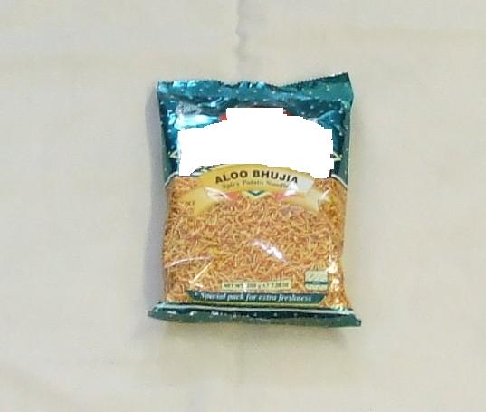 ALOO BHUJIA. SPICY POTATO NOODLES. INGREDIENTS INCLUDE POTATOES 44%, VEGETABLE OIL, GRAM PULSE FLOUR 4%, TEPARY BEANS FLOUR 2%, STARCH (SAGO), SPICES AND SALT. EXTRUDED PRODUCT. PACKAGED IN 200G POLY POUCHES.