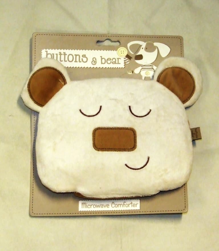 A PLUSH TOY IN THE SHAPE OF A BEARS HEAD. CONTAINS A REMOVEABLE WHEAT HEAT PACK WHICH CAN BE PLACED IN A MICROWAVE TO HEAT UP. PUT UP FOR RETAIL SALE ON A CARD WITH INSTRUCTIONS FOR USE TO CREATE WARMTH FOR A PUPPY.