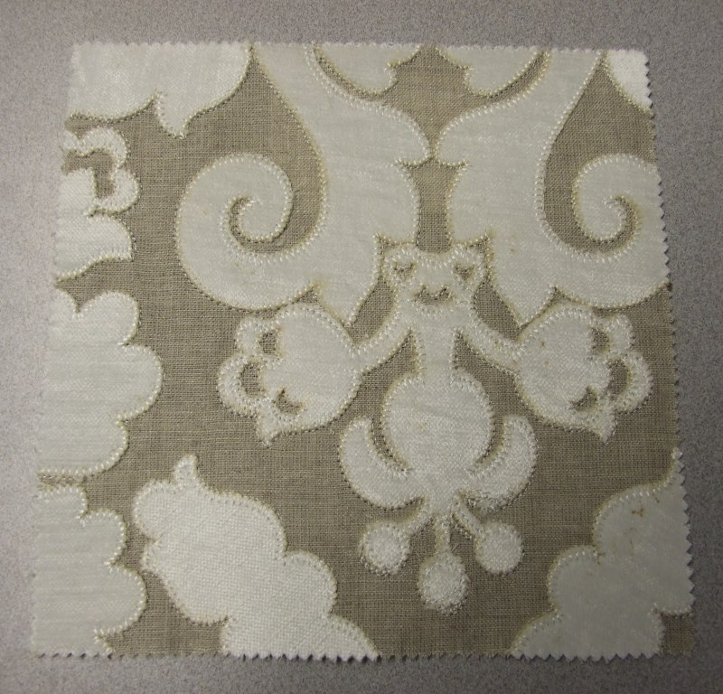 WOVEN EMBROIDERED FABRIC. VISIBLE GROUND FABRIC OF 100% LINEN, WITH EMBROIDERED PATTERN USING 98% VISCOSE AND 2% POLYESTER. TOTAL FIBRE CONTENT 44% LINEN, 44% COTTON, 11% VISCOSE AND 1% POLYESTER. WEIGHING 491 GRAMS PER METRE SQUARED. WIDTH 131CM. NOT MANUFACTURED ON A HAND LOOM. VALUE EXCEEDS 17.5 EUROS PER KG NET WEIGHT.