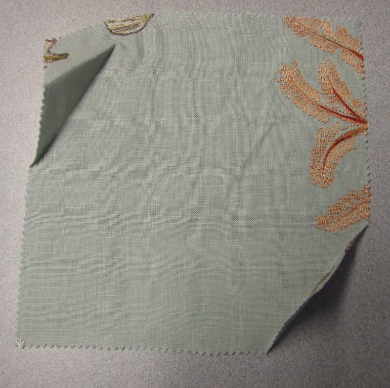 WOVEN EMBROIDERED FABRIC. VISIBLE GROUND FABRIC OF LINEN, WITH EMBROIDERED FLORAL PATTERN OF VISCOSE. TOTAL FIBRE CONTENT 71% LINEN AND 29% VISCOSE. WEIGHING 277 GRAMS PER METRE SQUARED. WIDTH 130CM. NOT MANUFACTURED ON A HAND LOOM. VALUE EXCEEDS 17.5 EUROS PER KG NET WEIGHT.