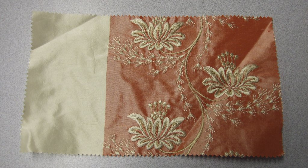 WOVEN EMBROIDERED FABRIC. VISIBLE GROUND FABRIC OF SILK, WITH EMBROIDERED FLORAL PATTERN OF VISCOSE. TOTAL FIBRE CONTENT 62% SILK AND 38% VISCOSE. WEIGHING 163 GM2. WIDTH 138CM. NOT MANUFACTURED ON A HAND LOOM. VALUE EXCEEDS 17.5 EUROS PER KG NET WEIGHT.