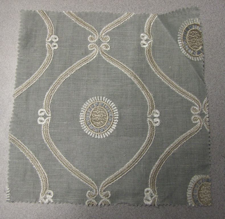WOVEN EMBROIDERED FABRIC. VISIBLE GROUND FABRIC OF LINEN, WITH EMBROIDERED PATTERN OF 91% VISCOSE AND 9% POLYESTER. TOTAL FIBRE CONTENT 57% LINEN, 39% VISCOSE AND 4% POLYESTER. WEIGHING 384 GM2. WIDTH 128CM. NOT MANUFACTURED ON A HAND LOOM. VALUE EXCEEDS 17.5 EUROS PER KG NET WEIGHT.