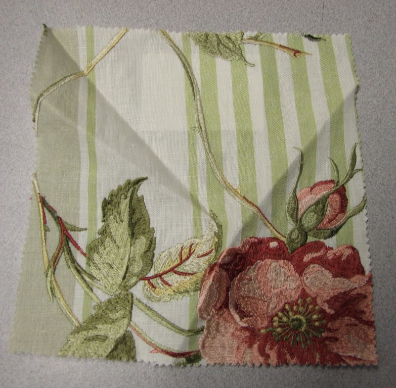 WOVEN EMBROIDERED FABRIC. VISIBLE GROUND FABRIC OF LINEN WITH EMBROIDERED FLORAL PATTERN VISCOSE. TOTAL FIBRE CONTENT 72% LINEN AND 28% VISCOSE. WEIGHING 307 GRAMS PER METRE SQUARED. WIDTH 137CM. NOT MANUFACTURED ON A HAND LOOM. VALUE EXCEEDS 17.5 EUROS PER KG NET WEIGHT.
