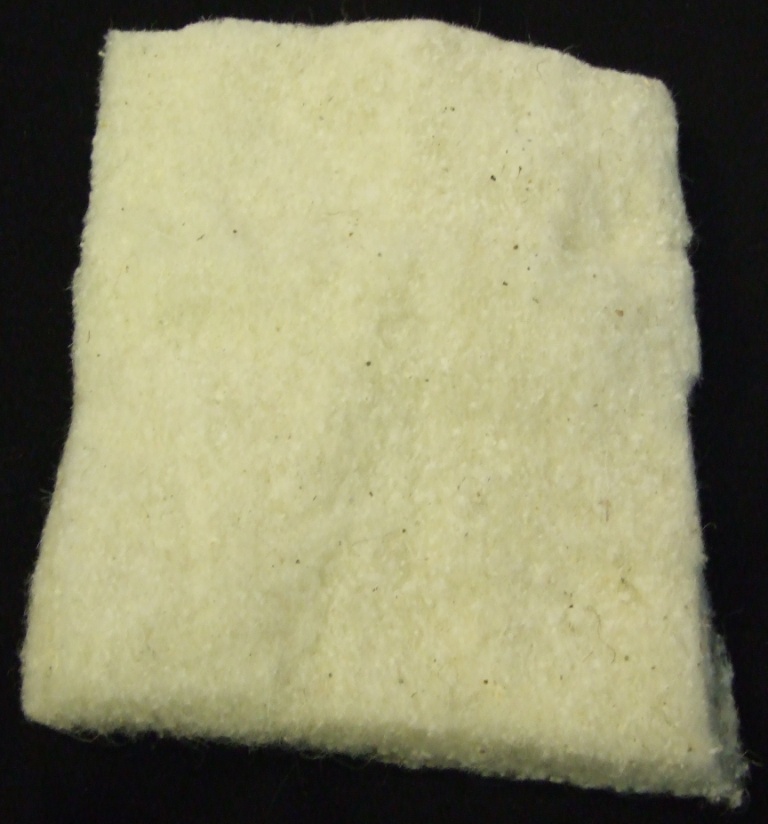 COMBED AND LAYERED SCOURED WOOL TO PRODUCE A WOOL FILLING PAD FOR A MATTRESS.