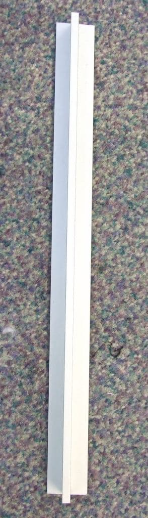 EXTRUDED PROFILE OF ALUMINIUM ALLOY, IN A 'T' SHAPE. TO BE CUT TO CORRECT LENGTH, AND USED TO SEPARATE SECTIONS OF ENTRANCE MATTING.