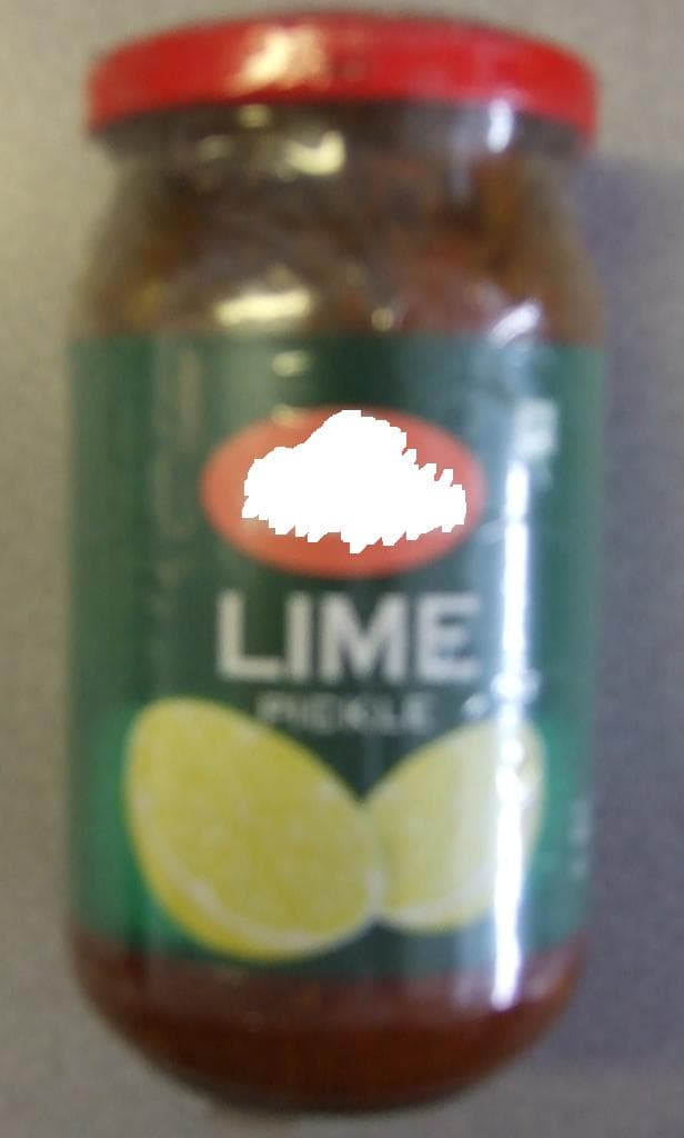 LIME PICKLE. LIME PIECES IN A SPICY SAUCE. INGREDIENTS INCLUDE LIME PIECES 65%, SUGAR 7.78%, SALT 13%, VEGETABLE OIL 5%  FENUGREEK 1.5% AND ACETIC ACID 2.10%. PACKAGED IN A GLASS JAR.