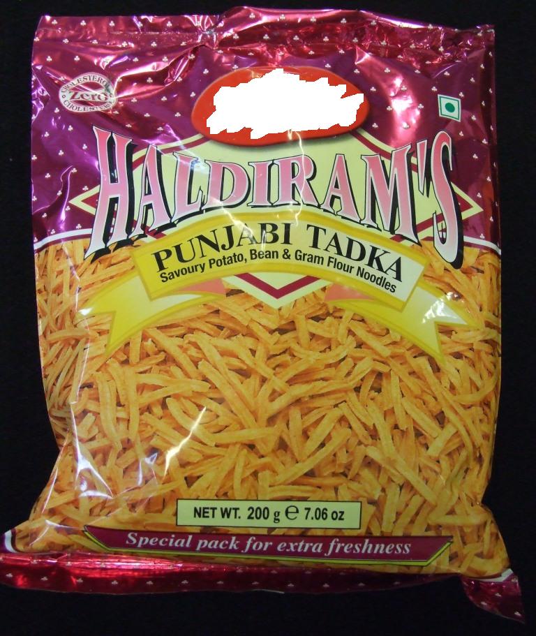 PUNJABI TADKA. SAVOURY POTATO, BEAN AND GRAM FLOUR NOODLES. INGREDIENTS INCLUDE POTATOES 40%, VEGETABLE OIL 37%, GRAM PULSE FLOUR 10%, TEPARY BEANS FLOUR 4%, EDIBLE STARCH 2% AND SALT 2%. EXTRUDED PRODUCT. PACKAGED IN 200G POLY POUCHES.