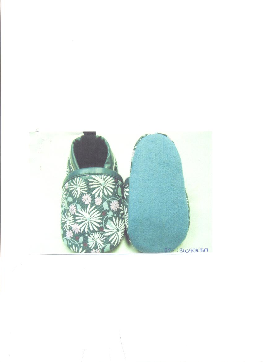 BABIES SLIPPER. WITH UPPERS OF LEATHER.  THE UPPER HAS A FLORAL DESIGN WITH WHITE AND PINK FLOWERS WITH LIGHT GREEN STEMS AND LEAVES. THE BACKGROUND IS DARK GREEN. THE UPPER HAS DARK GREEN EDGING AROUND THE VAMP AND AT THE TOP OF THE SLIPPER.  THE SOLE IS OF TEXTILE MATERIAL.