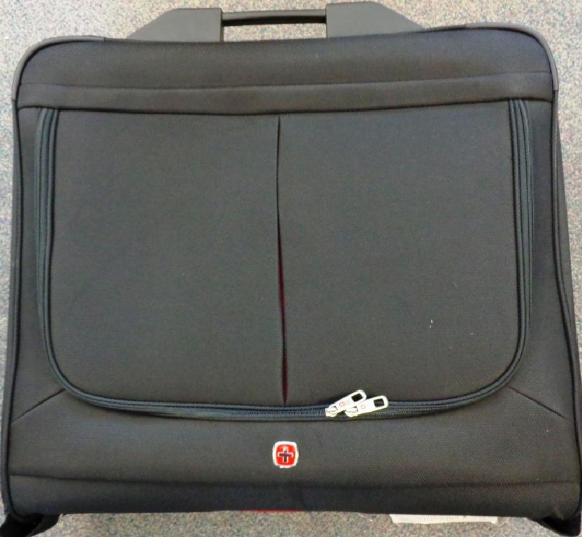 A RE-INFORCED TEXTILE SUITCASE DESIGNED AS A GARMENT BAG. CASE OPENS OUT TO 115 CM X 63 CM TO  ACCOMODATE GARMENTS WHICH CAN BE ATTACHED BY HANGERS SUPPLIED TO THE TOP OF THE CASE. WITH ELASITC STRAP ACROSS THE TOP HALF OF THE INTERIOR OF THE CASE TO KEEP THE GARMENTS IN PLACE. WITH VARIOUS INTERIOR POCKETS TO ACCOMODATE OTHER ITEMS OF CLOTHING. WITH NYLON INTERIOR COVER WHICH FASTENS WITH A ZIP TO COMPLETELY COVER THE CLOTHES.  FASTENED WITH A ZIP ON EXTERIOR  THREE SIDES OF THE CASE. WITH CARRY HANDLE  AND CONCEALED HANDLE WHICH PULLS UP TO ENABLE THE CASE TO BE WHEELED.  TWO WHEELS AT BASE OF CASE AND A PLASTIC STAND TO PROTECT THE CASE WHEN STANDING.