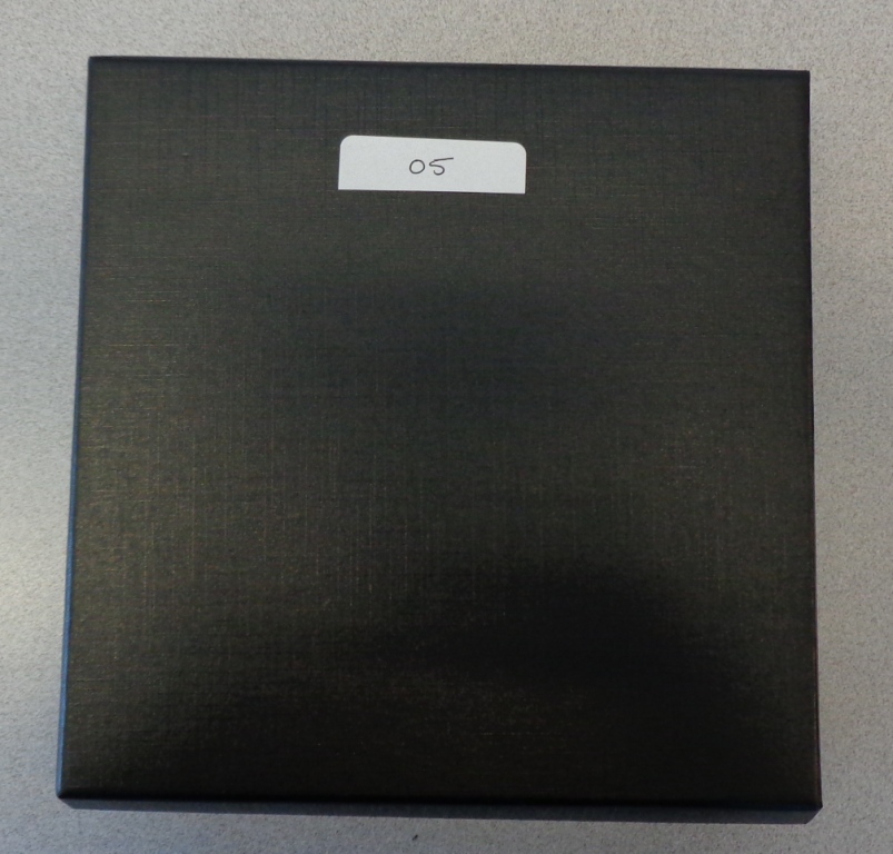 THIS IS A BOX USED TO GIVE AWAY JEWELLERY OR GIFTS FOR PRESENTATION PURPOSES. IT IS BLACK IN COLOUR. IT IS MADE OF CARDBOARD. DIMENSIONS ARE 18X18X5CMS
