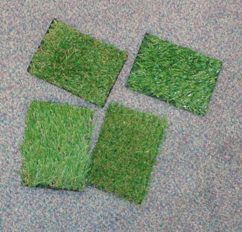 ARTIFICIAL GRASS. MADE FROM POLYPROPYLENE MONOFILAMENT STRANDS, EACH OF WHICH IN CROSS SECTION IS LESS THAN 5MM WIDE AND LESS THAN 1MM IN THICKNESS. THESE STRANDS ARE TUFTED INTO A BASE OF WOVEN TEXTILE AND STYRENE - BUTODIENE RUBBER.