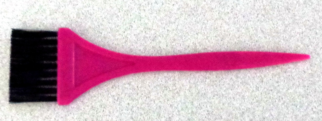 PLASTIC BRUSH. WITH NYLON BRISTLES USED TO APPLY HAIR COLOURANT. MEASURES 150MM X 40MM APPROX. HANDLE PURPLE IN COLOUR.