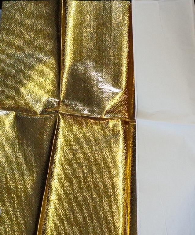 GOLD METALIZED POLYESTER FILM ON A WHITE VINYL ACRYLIC ADHESIVE BACKING. A SOFT GOLD REFLECTOR USED IN MOVIE AND TV PRODUCTIONS. ITEM IS PRODUCED BY HEAT LAMINATING WHITE PLASTIC PVC AND GOLD METALIZED POLYESTER TOGETHER. ITEM IS EMBOSSED SHOWING THE SAME PATTERN ON BOTH SIDES AND THE WORKING SURFACE IS CONSIDERED TO BE THE GOLD ONE. THERE IS NO STICKY OR PEEL AWAY SURFACE APPARENT ALTHOUGH ADHESIVE COATING STATED. NOMINAL THICKNESS 0.1MM ITEM TO BE SOLD IN ROLLS 6.10 M LONG AND 1.52 M WIDE.