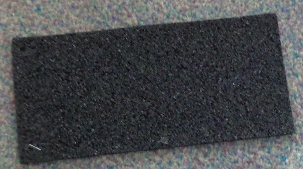 RUBBER UNDERLAY FLOOR COVERING MADE FROM RECYCLED TYRE TREAD WITH A LATEX BONDING AGENT. IT IS FIVE MILLIMETRES THICK. IT IS BACKED WITH A THIN NON WOVEN POLYPROPYLENE MATERIAL WHICH IS STICKY AND COVERED WITH A FILM WHICH PEELS OFF WHEN READY FOR USE.  EACH ROLL OF UNDERLAY IS ONE METRE WIDE AND TEN METRES LONG. THE EDGES ARE NOT MOULDED OR BEVELLED.