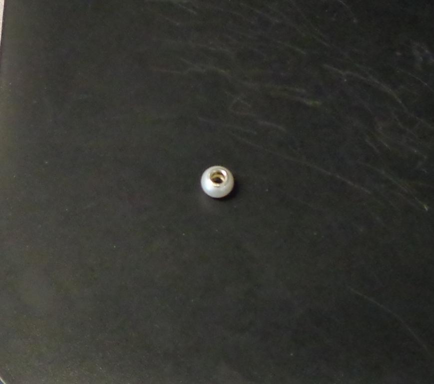 A JEWELLERY BEAD WHICH IS A FRESHWATER PEARL OUTSIDE A STERLING SILVER INSERT.
