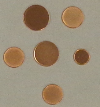 COPPER PLATED COIN BLANKS. DISCS STAMPED FROM MILD STEEL STRIP, PRE ROLLER TO REQUIRED THICKNESS. THE EDGE OF THE BLANK IS MECHANICALLY RAISE AND THE BLANKS ARE THEN ELECTRO PLATED WITH COPPER TO THE REQUIRED PLATING THICKNESS. THE BLANKS ARE THEN ANNEALED AND WASHED READY FOR ISSUE.
