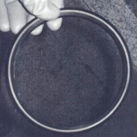 SUCTION FILTER. THE DEVICE IS AN OIL FILTER TO REMOVE CONTAMINANTS FROM OIL. THE DEVICE IS CONSTRUCTED OF A STEEL RING WITH A FIBRE FILTER ENCLOSED WITHIN THE RING. THE DEVICE IS PART OF A HIGH PRESSURE DIE CASTING MACHINE. THE DEVICE IS NOT MACHINE SPECIFIC.