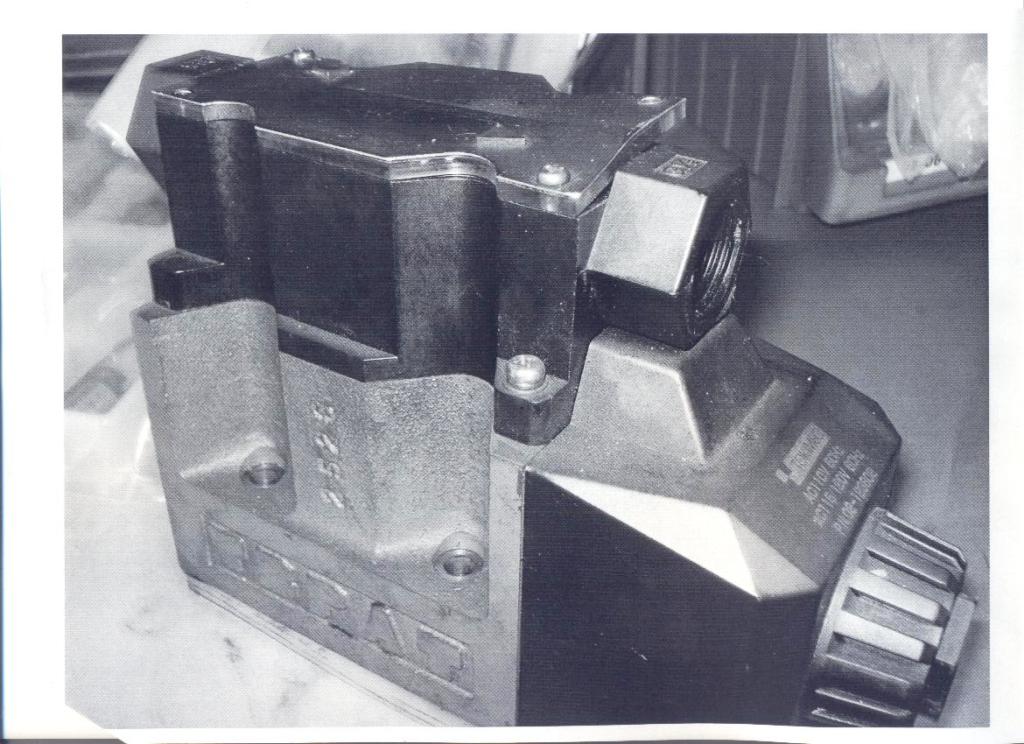 A DIRECTIONAL CONTROL VALVE FOR HYDRAULIC FLUID MOVEMENT. THE VALVE IS MADE OF STEEL. THE VALVE IS PART OF A HIGH PRESSURE DIE CASTING MACHINE. THE VALVE IS NOT MACHINE SPECIFIC AND IS A PART OF GENERAL USE.