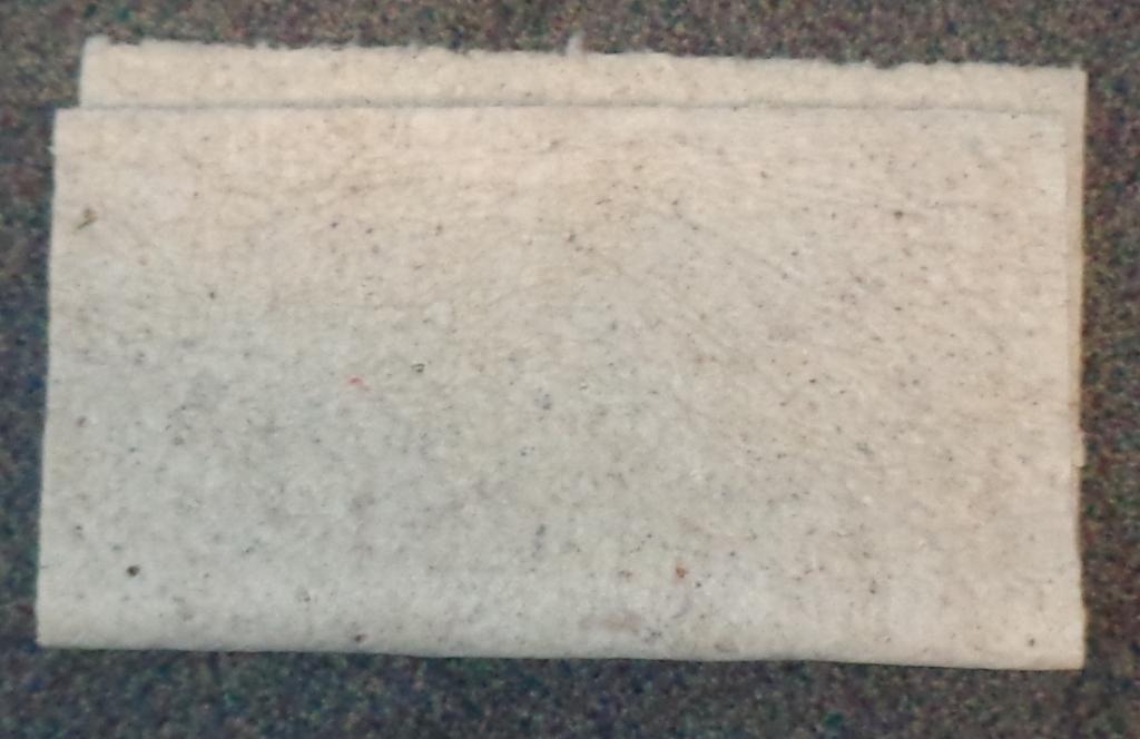 A NON WOVEN PRODUCT PRESENTED ON THE ROLL (MEASURING 36CM X 22 M). MADE UP WITH PERFORATIONS ALONG THE LENGTH AND AT REGULAR INTERVALS ACROSS THE WIDTH FOR EASY SEPARATION INTO PIECES MEASURING 41CM X 17.5CM. TO BE USED TO ABSORB SPILLS. WHITE IN COLOUR. OUTER LAYERS OF POLYPROPYLENE MANUFACTURED USING THE MELT BLOWN PROCESS. INNER LAYER MADE FROM RECYCLED COTTON FIBRES (WADDING). TOTAL THICKNESS DOES NOT EXCEED 50MM. PLAIN MELTBLOWN. WEIGHING MORE THAN 150G/M2.