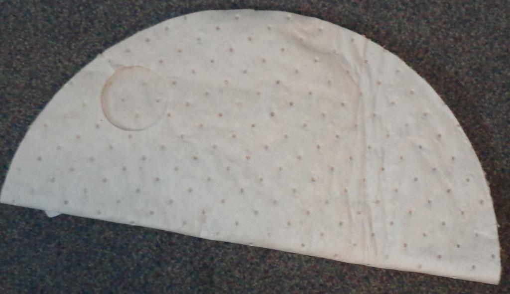 NON WOVEN PRODUCT, CIRCULAR IN SHAPE (MEASURING 558MM IN DIAMETER). MADE UP WITH TWO CUT OUT HOLES ON OPPOSITE SIDES/EDGES. TO BE USED TO ABSORB SPILLS. OFF WHITE IN COLOUR. OUTER LAYERS OF POLYPROPYLENE MANUFACTURED USING THE MELT BLOWN PROCESS. INNER LAYER MADE FROM RECYCLED COTTON FIBRES (WADDING). TOTAL THICKNESS DOES NOT EXCEED 50MM. PLAIN MELTBLOWN. WEIGHING MORE THAN 150G/M2.