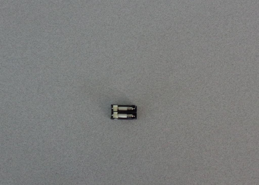 A CARTRIDGE FUSE ASSEMBLY CONTAINING TWO 5 X 20 MM FUSES (AXIAL) IN A BLACK PLASTIC HOUSING.  THE FUSES ARE FAST, CERAMIC, LEADED, 8A 250V. DESIGNED TO BE MOUNTED ON A PCB.