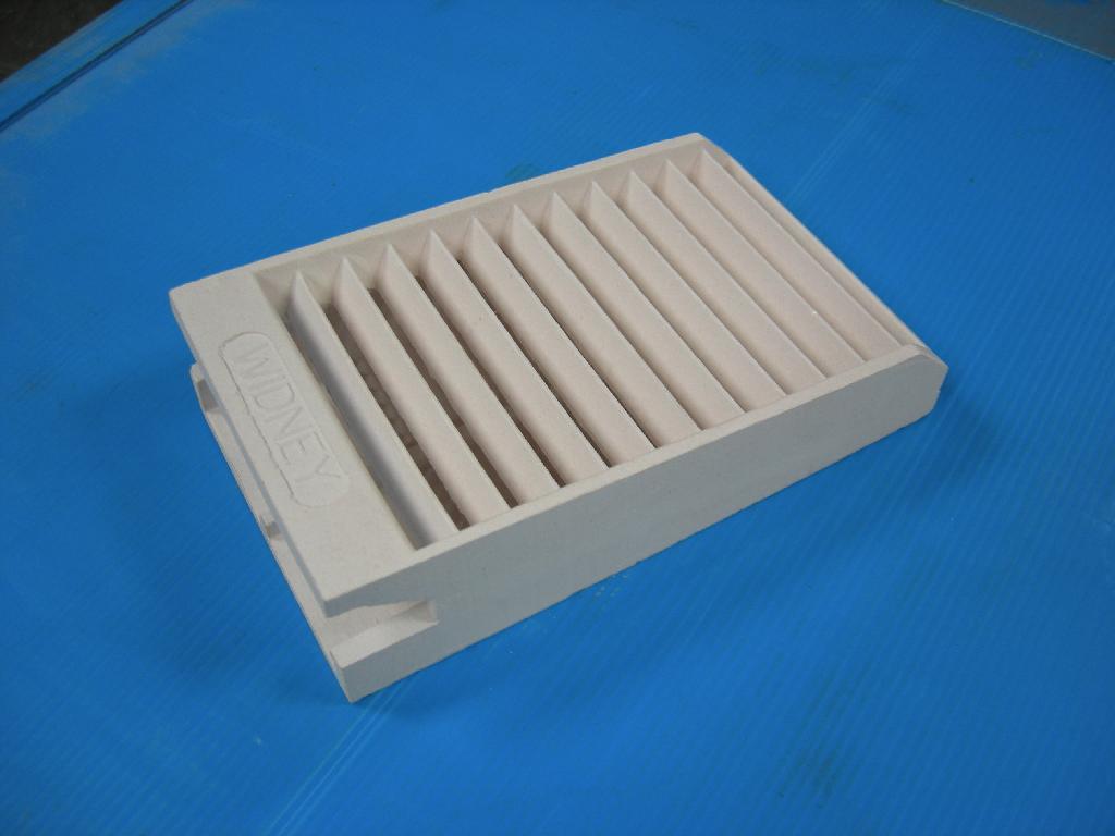 GAS FIRE RADIANT. OF 65 PERCENT FIRED CLAY, 23 PERCENT SILICA AND 12 PERCENT OTHER MATERIALS. DESIGNED TO BE FITTED INTO GAS FIRES TO RADIATE HEAT.  MEASURES APPROX 20CM X 28 CM.