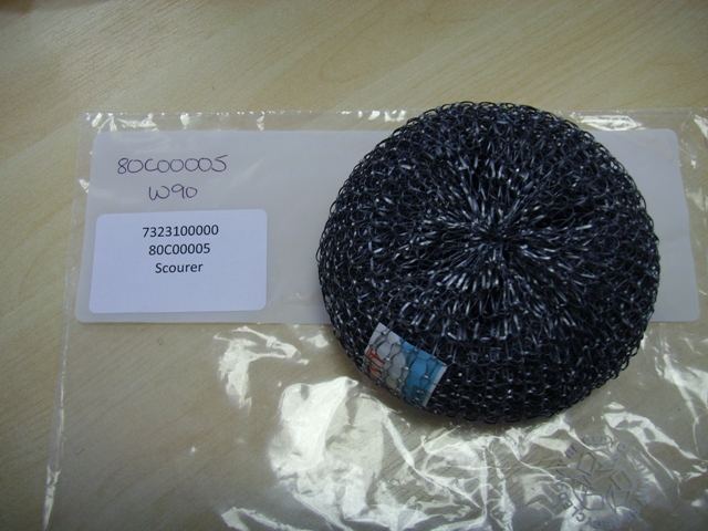 A PAN SCOURING PAD OF GALVANISED STEEL WOOL.