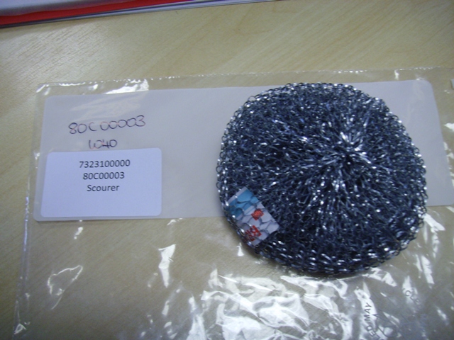 A PAN SCOURING PAD OF GALVANISED STEEL WOOL.