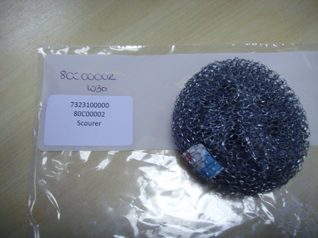 A PAN SCOURING PAD OF GALVANISED STEEL WOOL.