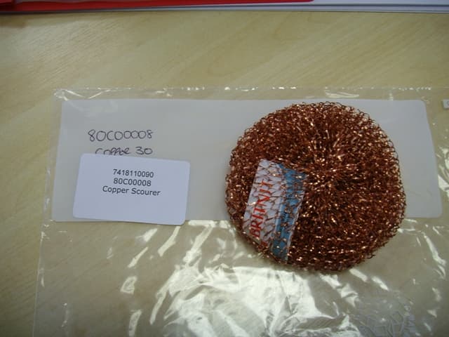 A POT SCOURER OF COPPER.