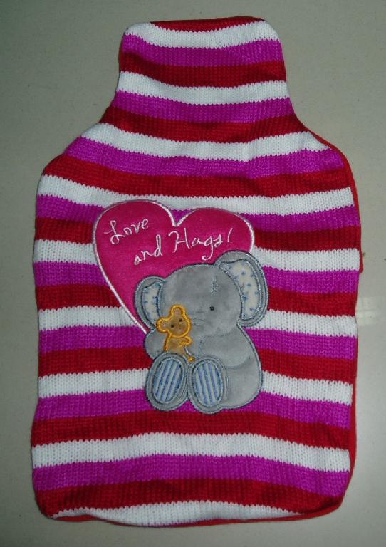 HOT WATER BOTTLE. MADE FROM NATURAL RUBBER. WITH TEXTILE COVER WITH ELEPHANT MOTIF.